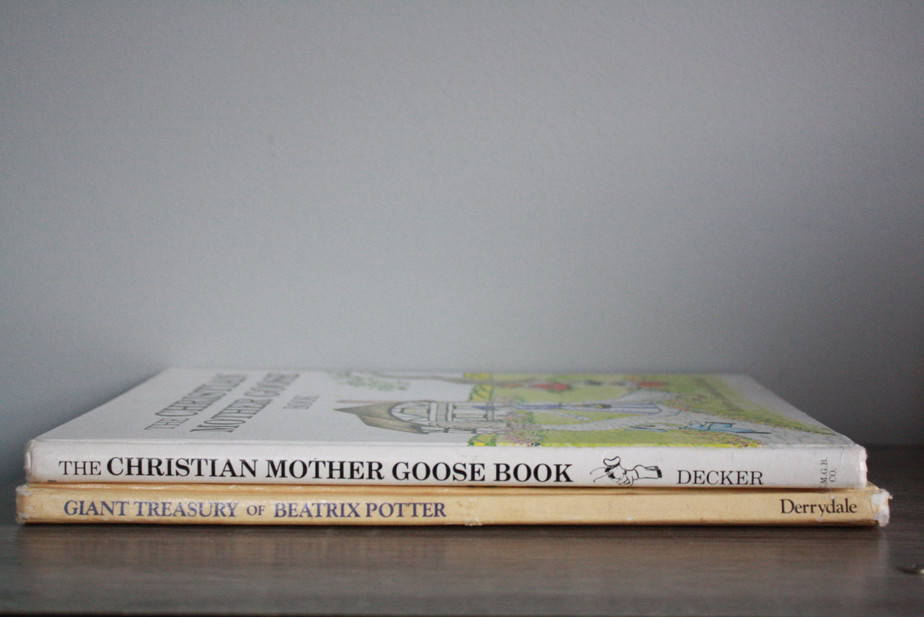 the christian mother goose book and the giant treasury of beatrix potter book on nightstand