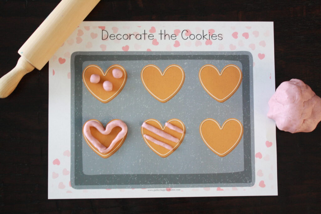 Valentine's day free printable playdough mat. Heart shaped cookies to decorate using playdough for Valentine's Day kid activities.