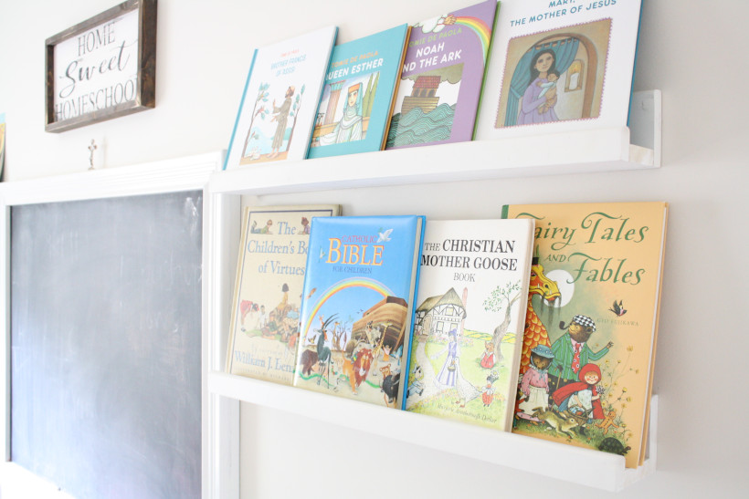 White ledge shelves displaying mother goose and Bible Story books.