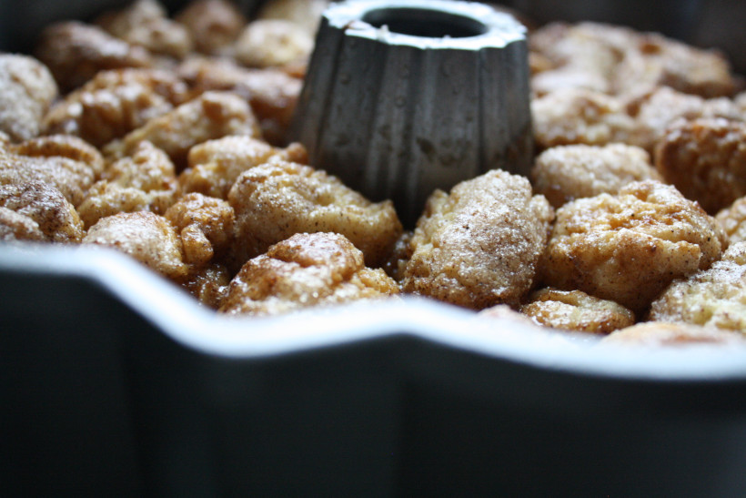 Baked monkey bread in bundt pan cooling on kitchen counter.
