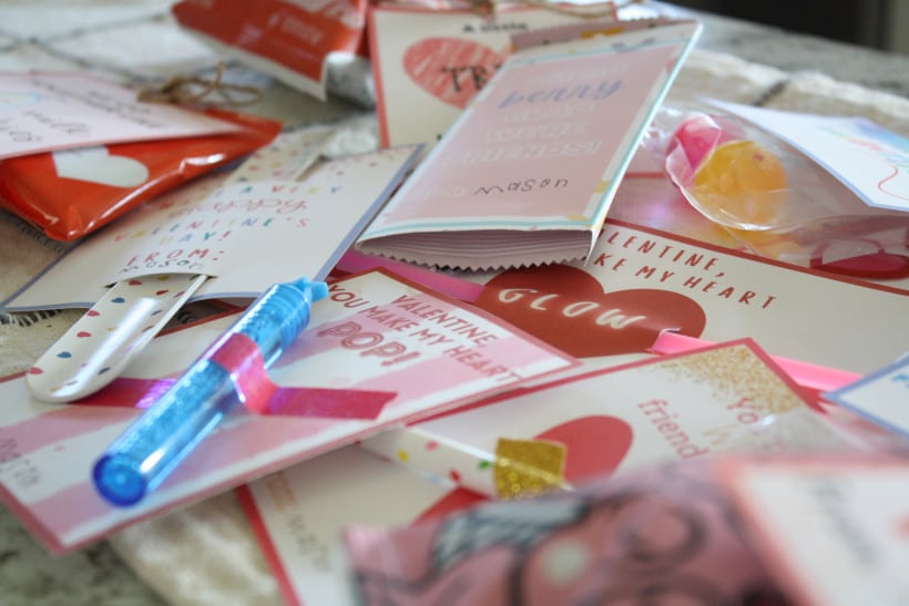 15 free printable valentines cards for kids assembled and displayed on kitchen counter.