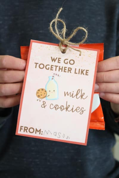 Child holding the completed we go together like milk and cookies valentine card.