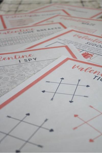 Free printable valentine's day games printed and displayed on table.